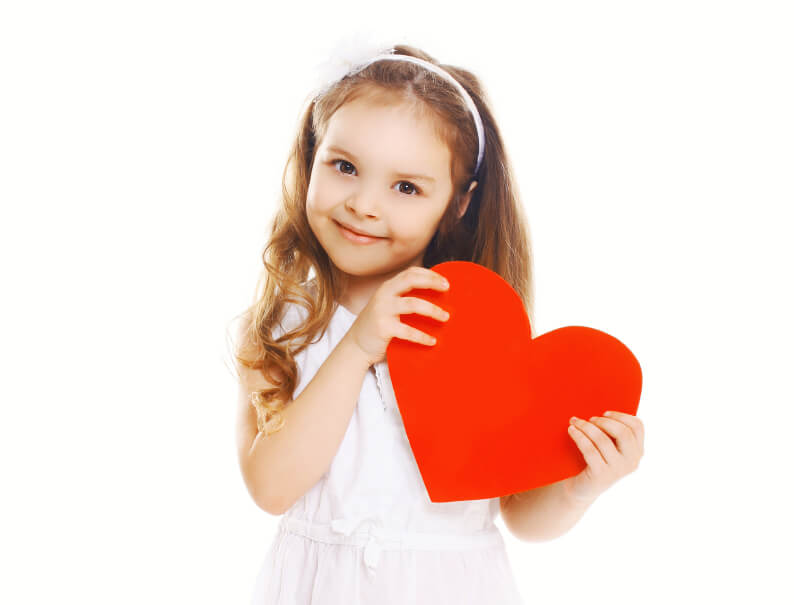 Young child holding a heart for Valentine's Day