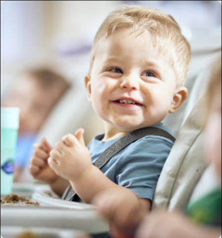 infant sitting in high chair