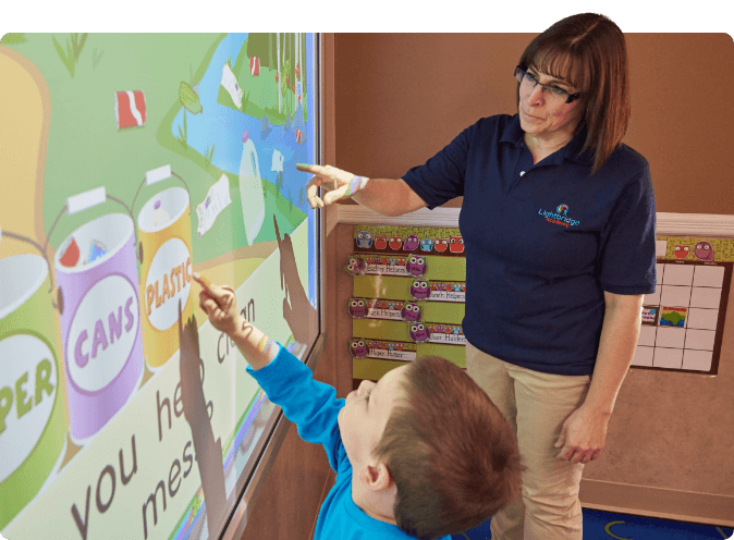 teacher works with student on kindergarten readiness